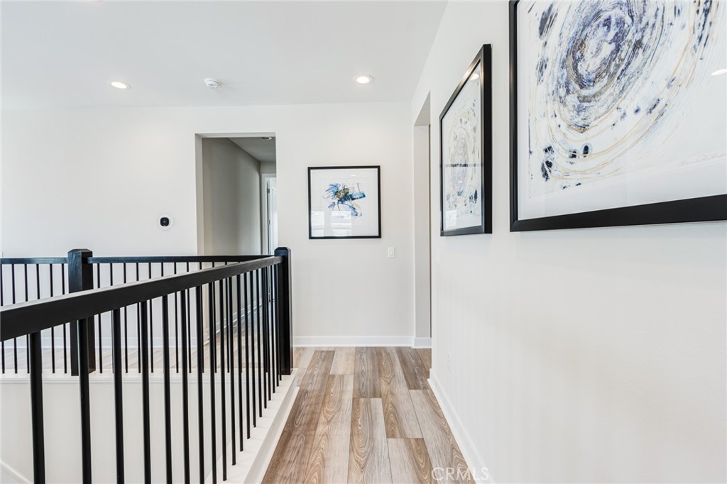 260 Holliston Lake Forest, CA 92630 - Photo 36 of 63 a view of a hallway with paintings on the wall