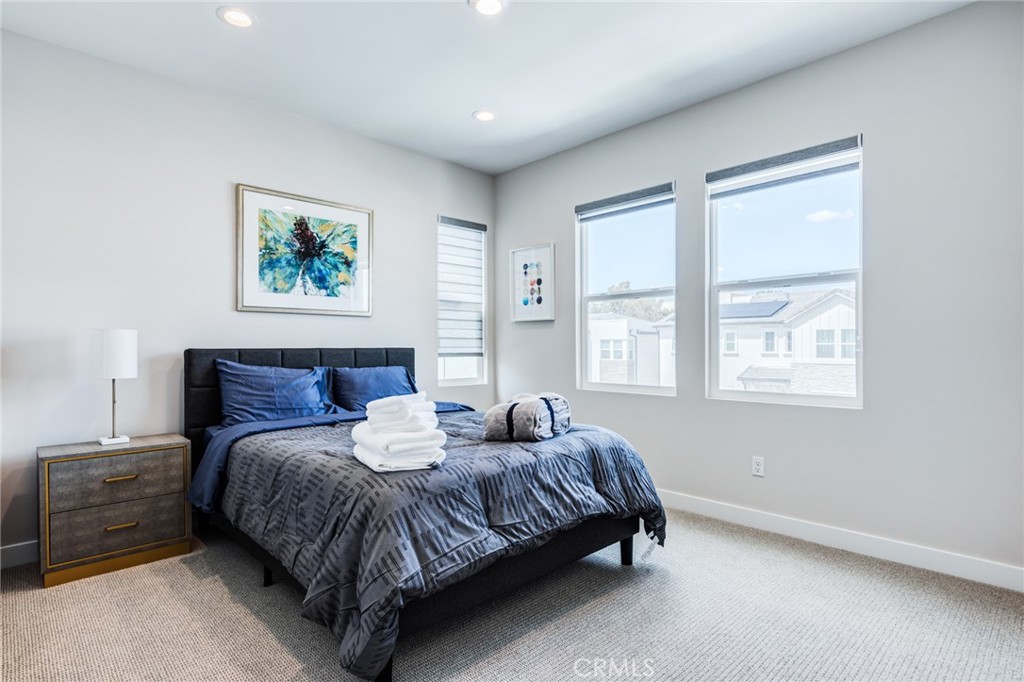 260 Holliston Lake Forest, CA 92630 - Photo 50 of 63 a spacious bedroom with a bed a wall painting and window