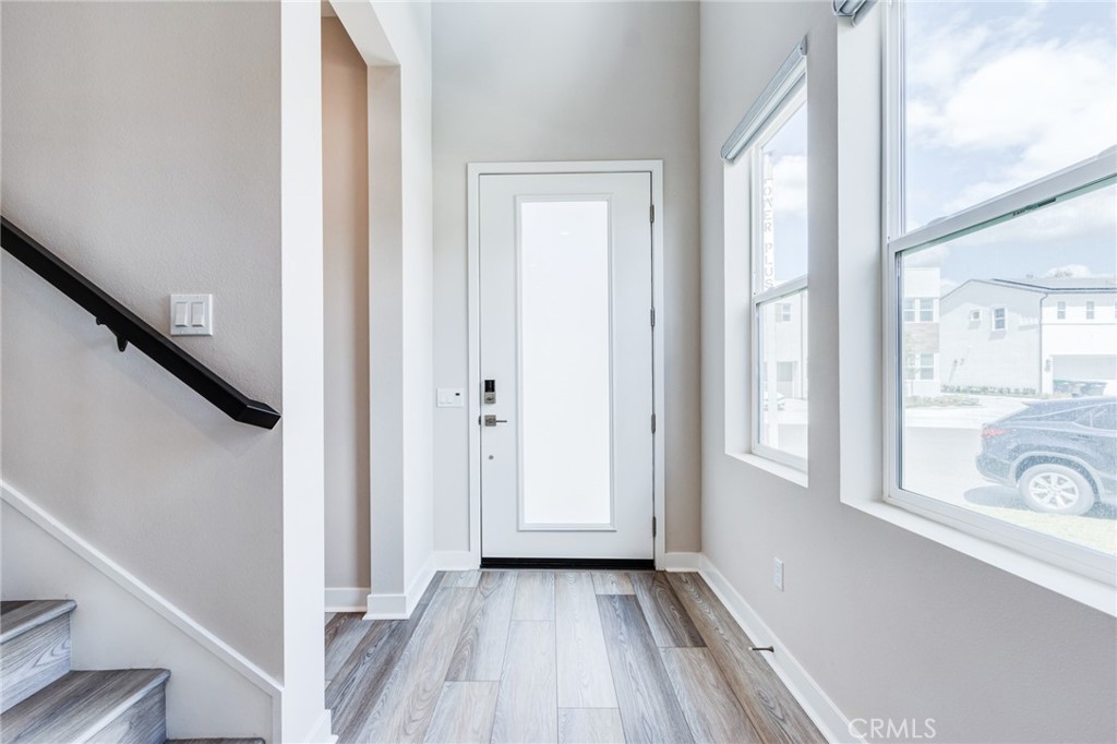260 Holliston Lake Forest, CA 92630 - Photo 10 of 63 a view of a hallway with wooden floor and staircase