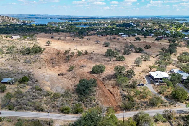 a view of a lake with beach and city space