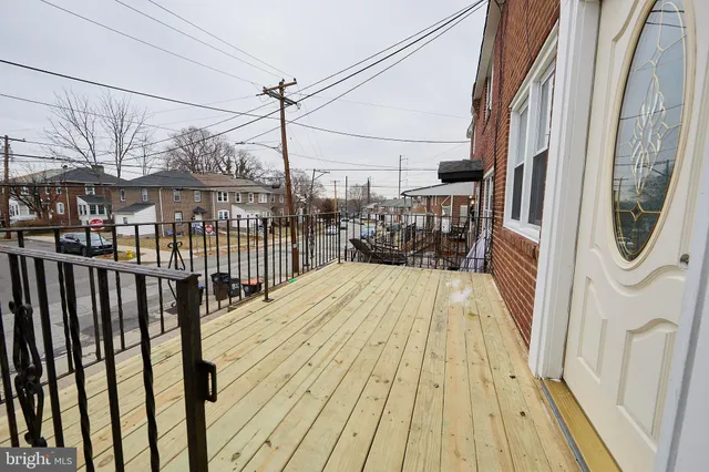 a view of balcony with wooden floor and bench