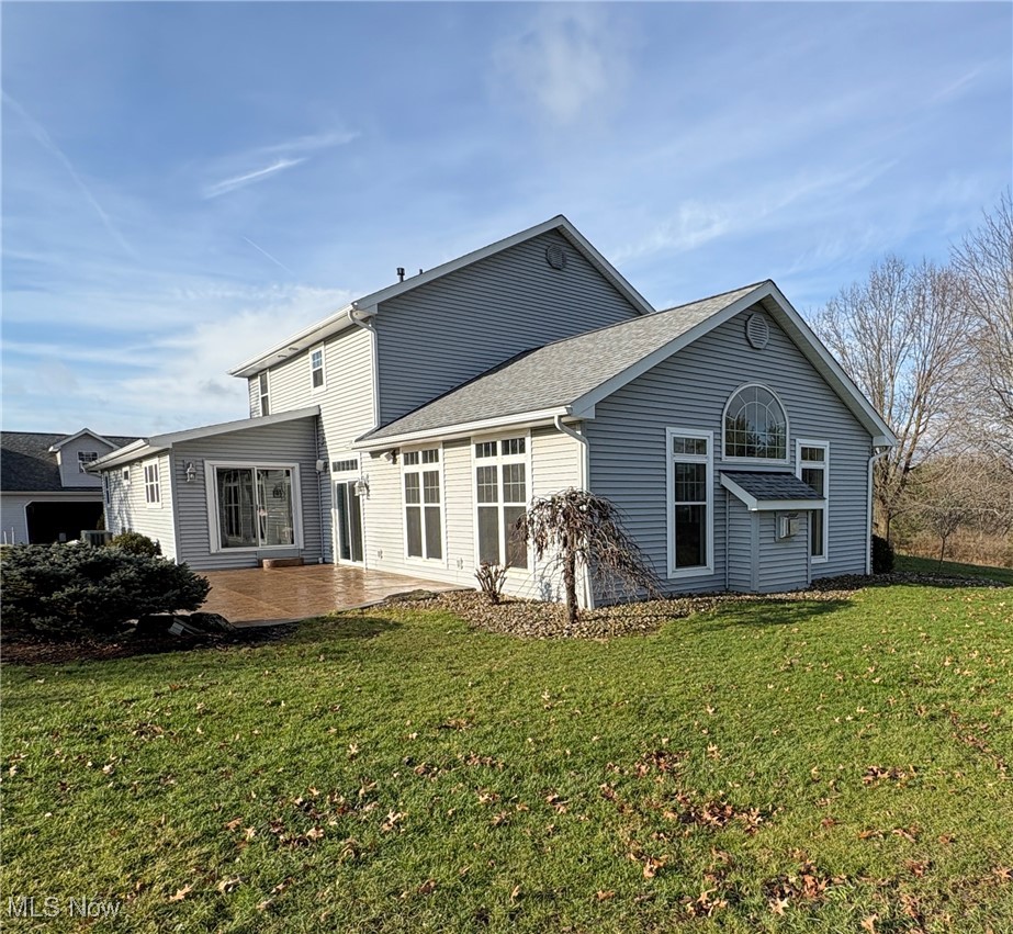 2504 Meloy Road Kent, OH 44240 - Photo 3 of 50 Back of house featuring a patio and a lawn