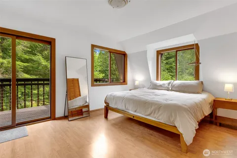 a bedroom with a bed and a large window