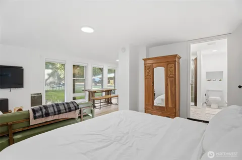 a bedroom with furniture and a flat screen tv