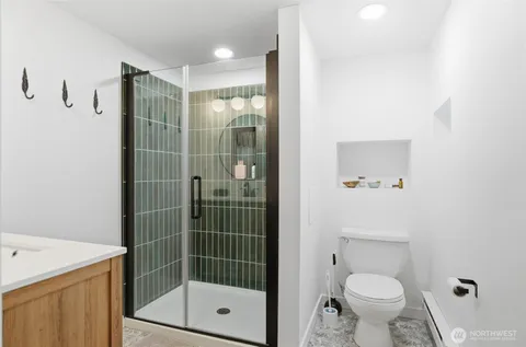 a bathroom with a shower toilet and sink