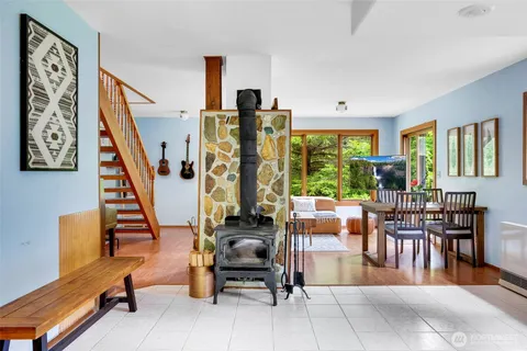 a living room with furniture a large window and a dining table
