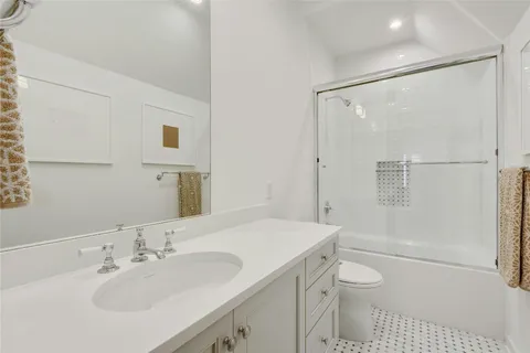 a bedroom with two beds and a desk