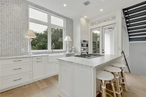 a kitchen with a sink and chairs