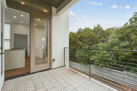 a view of a bedroom with wooden floor and a window