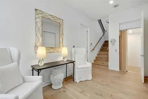 a living room with furniture a table and chairs