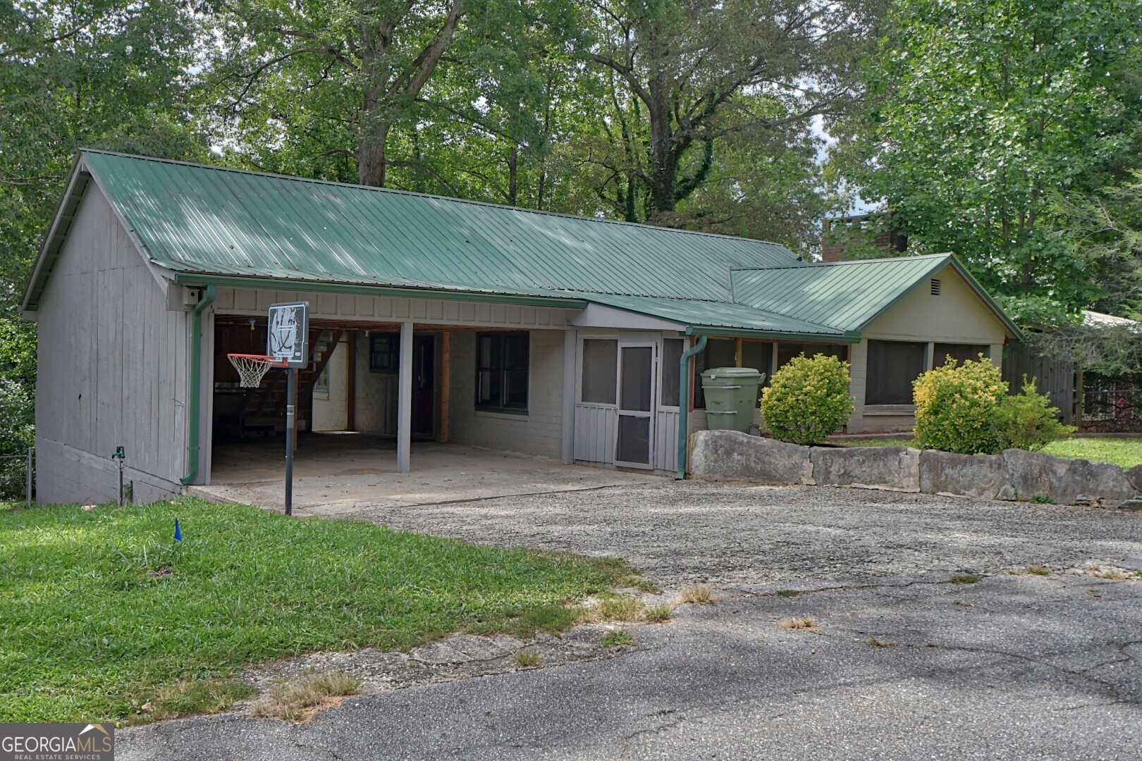 a view of a house with a yard and large tree