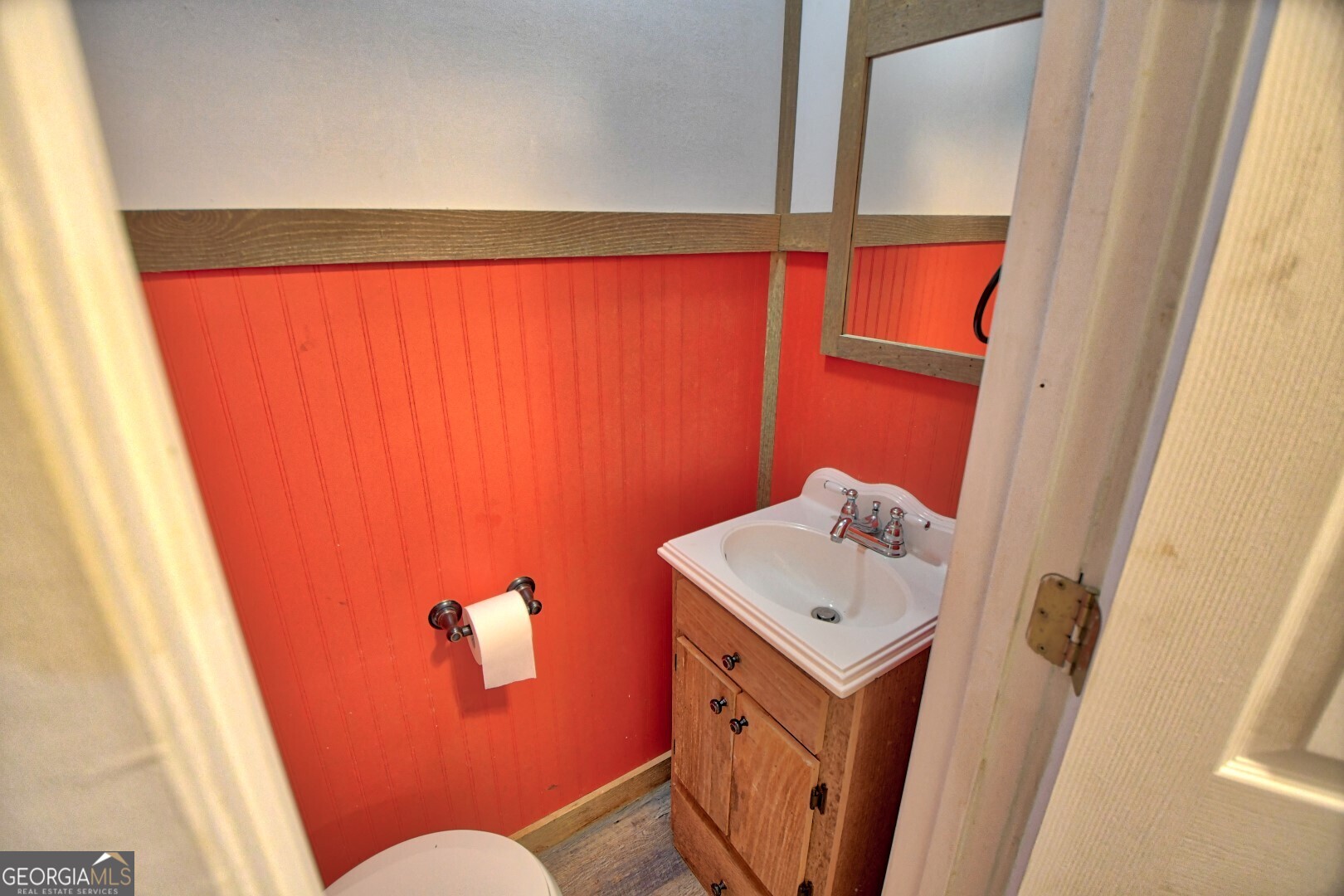 66 Post Oak Street Clayton, GA 30525 - Photo 16 of 17 a bathroom with a sink a mirror and a toilet