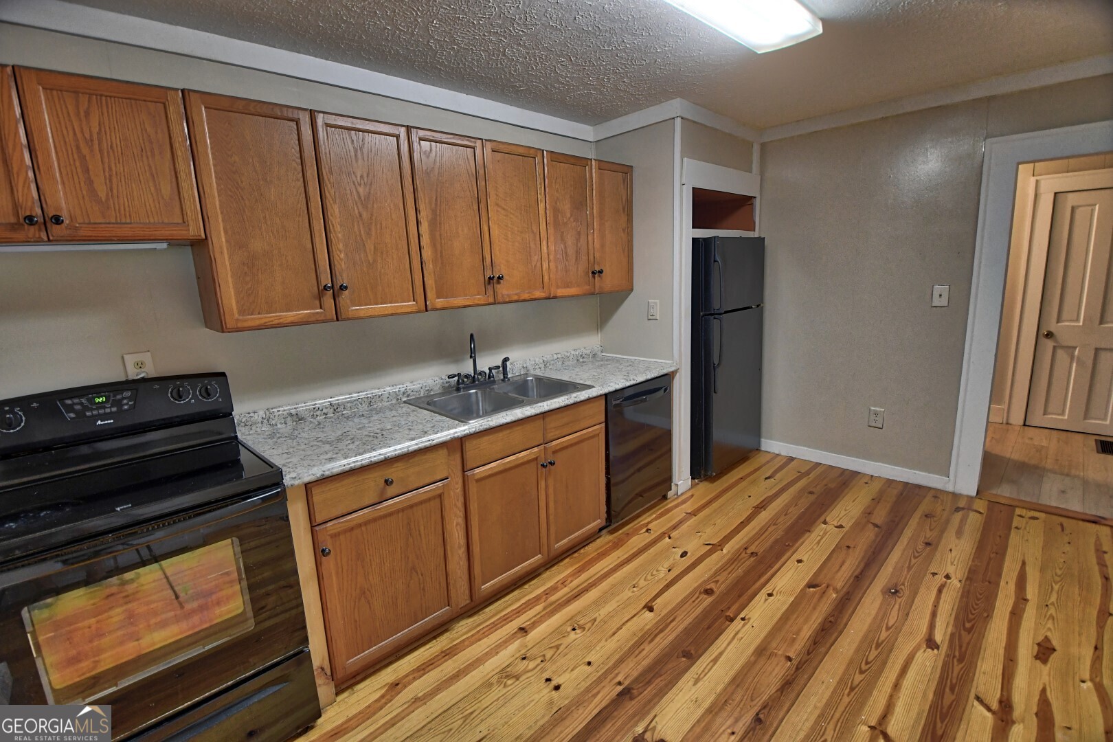 66 Post Oak Street Clayton, GA 30525 - Photo 9 of 17 a kitchen with wooden cabinets and a stove top oven