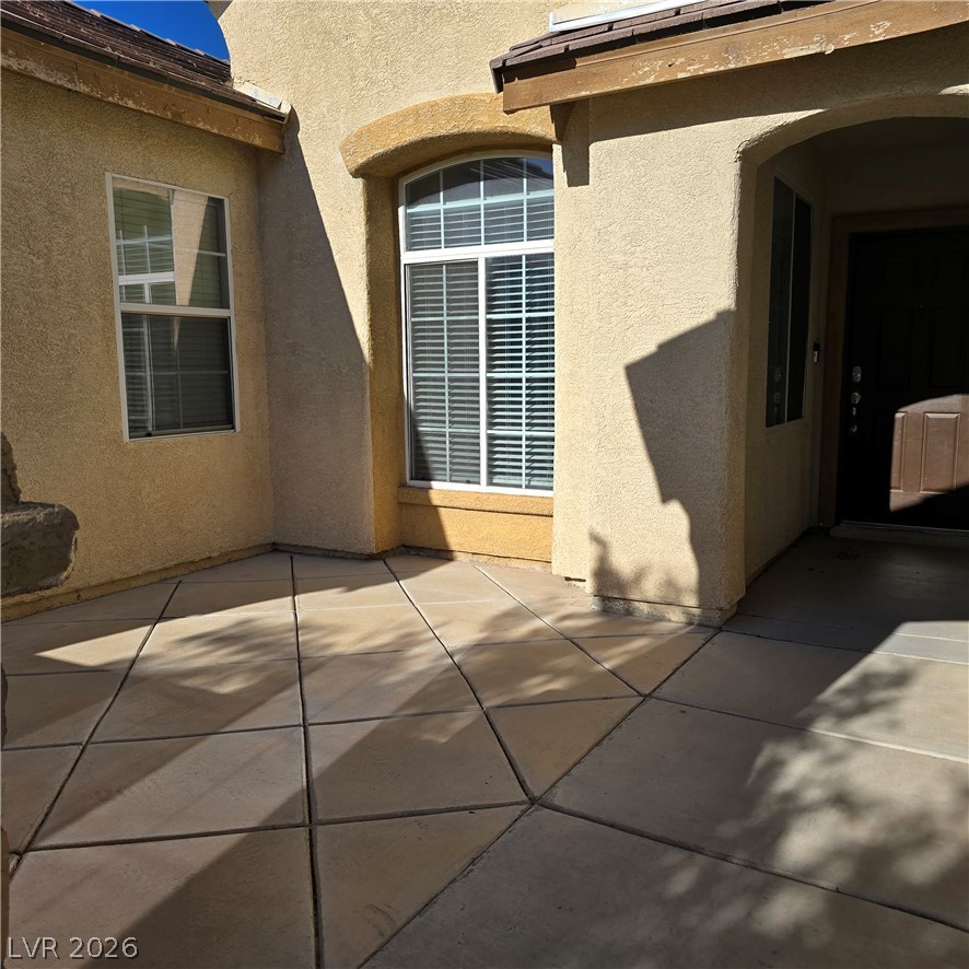 9234 Kingston Road Henderson, NV 89074 - Photo 6 of 38 A welcoming entry features a covered porch and patterned concrete flooring.