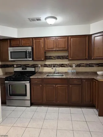 a kitchen with a sink a stove and a microwave