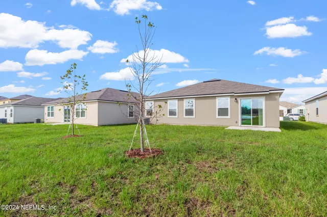 a view of a yard in front of a house with a yard
