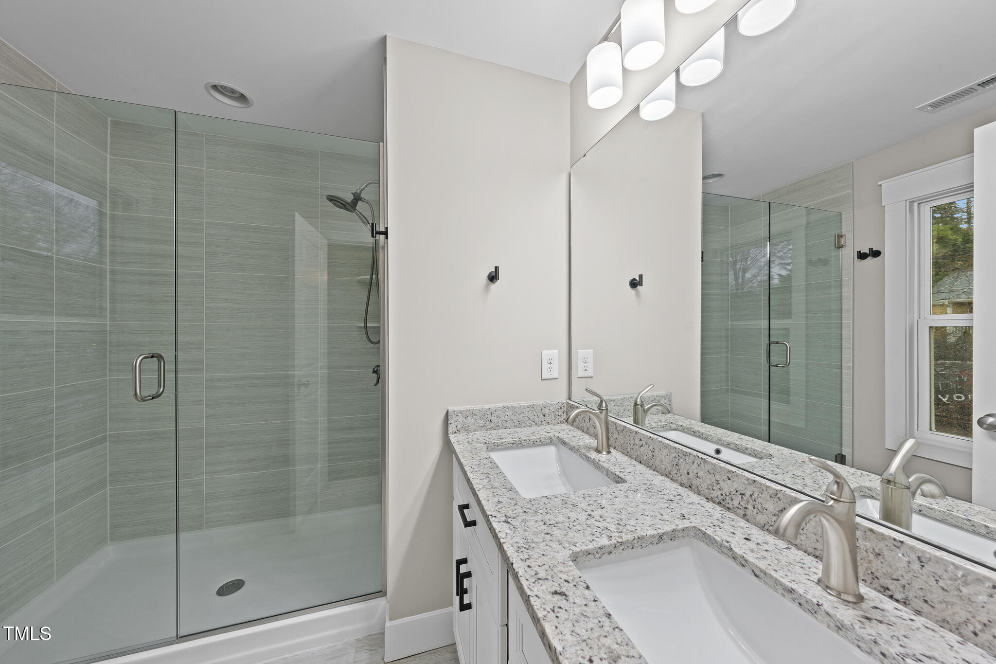 2717 Newbold Street Raleigh, NC 27603 - Photo 17 of 29 a bathroom with a granite countertop double vanity sink mirror and shower