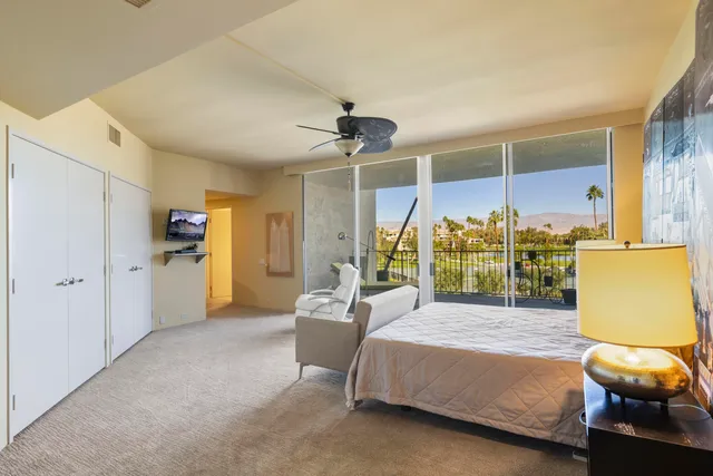 a view of a hallway with workspace and a window