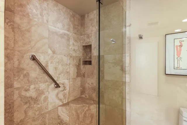 a bathroom with a glass shower door