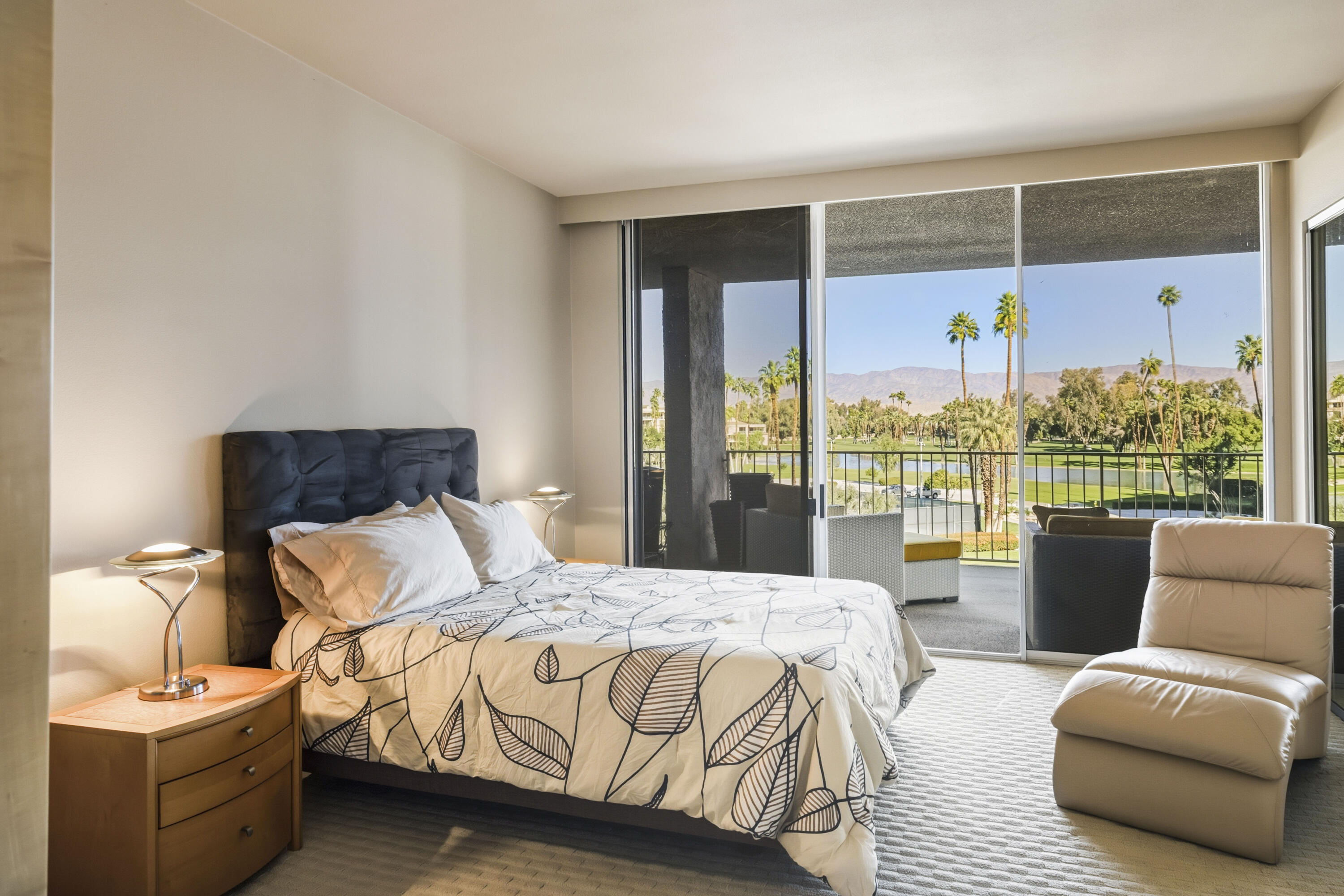 899 Island Drive, Unit 402 Rancho Mirage, CA 92270 - Photo 18 of 40 a bedroom with a bed and a couch