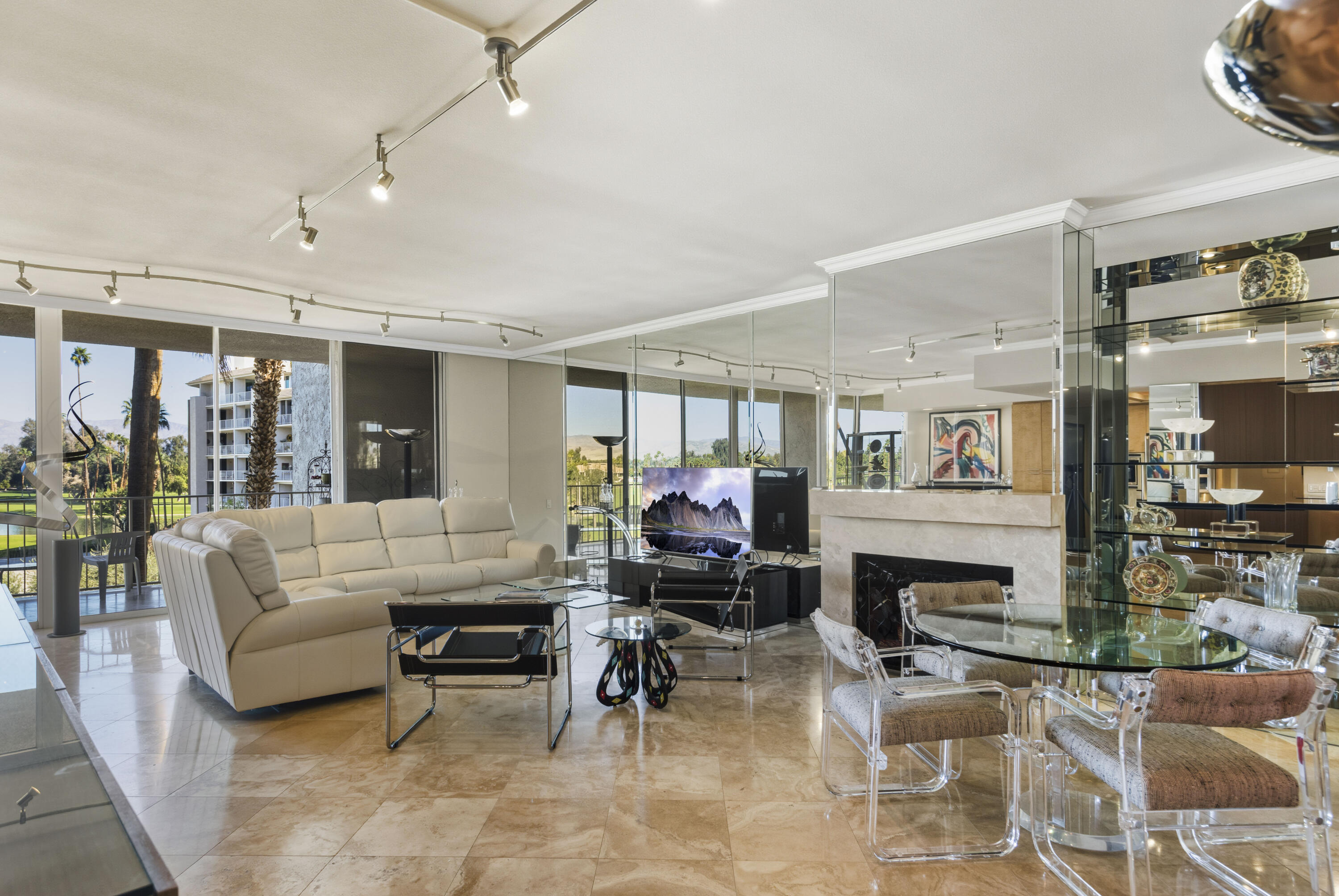 899 Island Drive, Unit 402 Rancho Mirage, CA 92270 - Photo 2 of 40 a living room with furniture and a fireplace