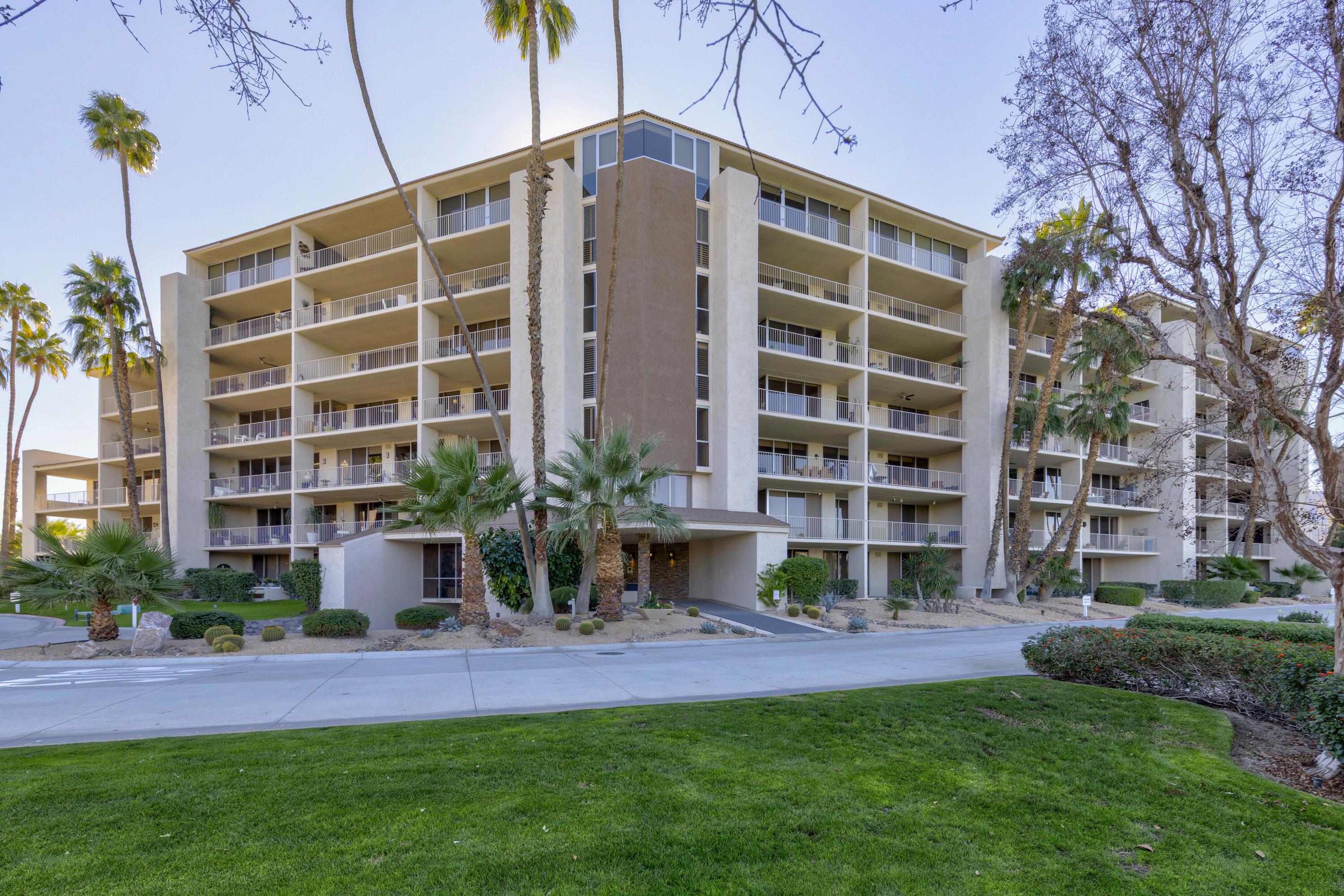 899 Island Drive, Unit 402 Rancho Mirage, CA 92270 - Photo 30 of 40 a front view of a building with a garden