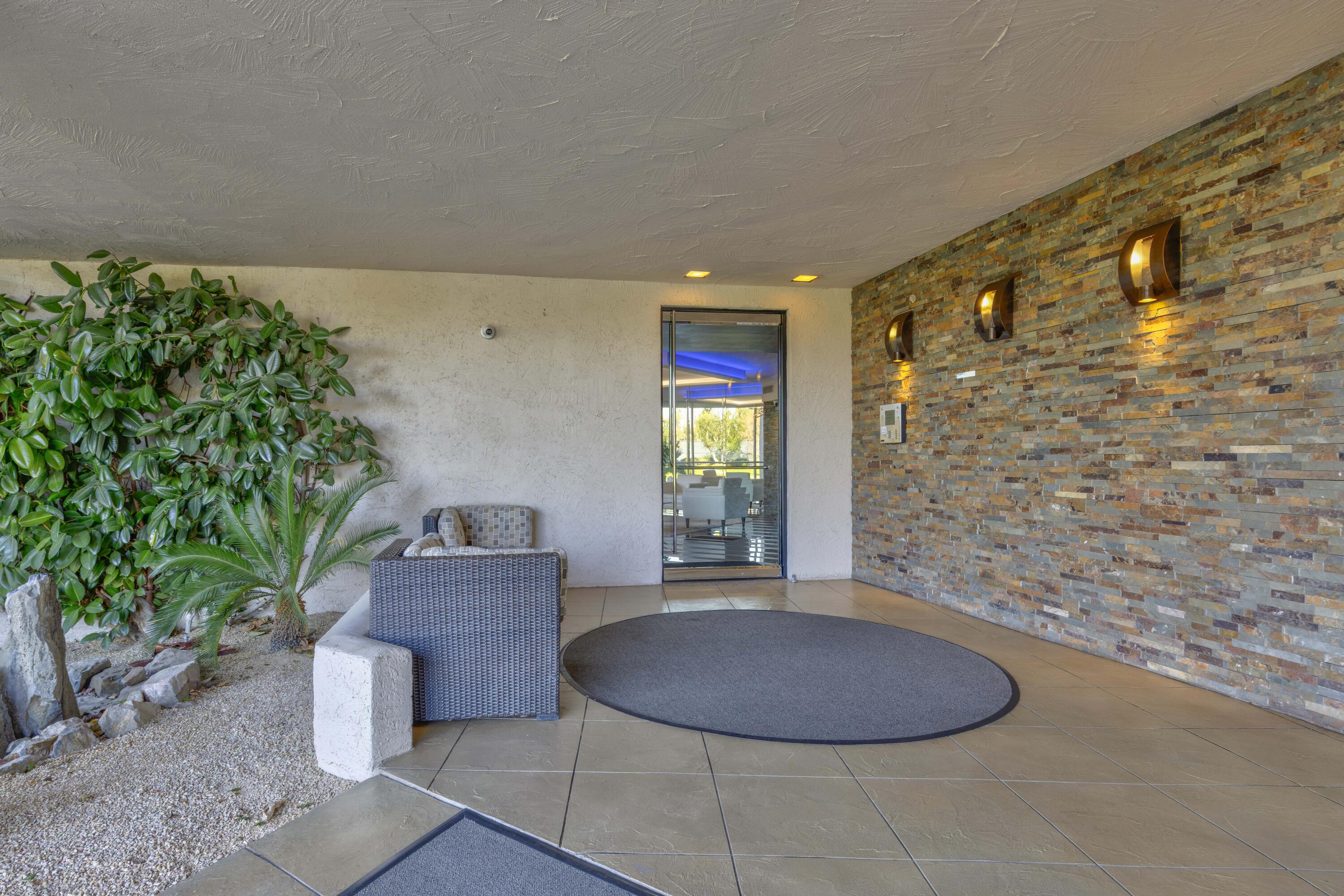 899 Island Drive, Unit 402 Rancho Mirage, CA 92270 - Photo 31 of 40 a view of a livingroom with furniture and yard