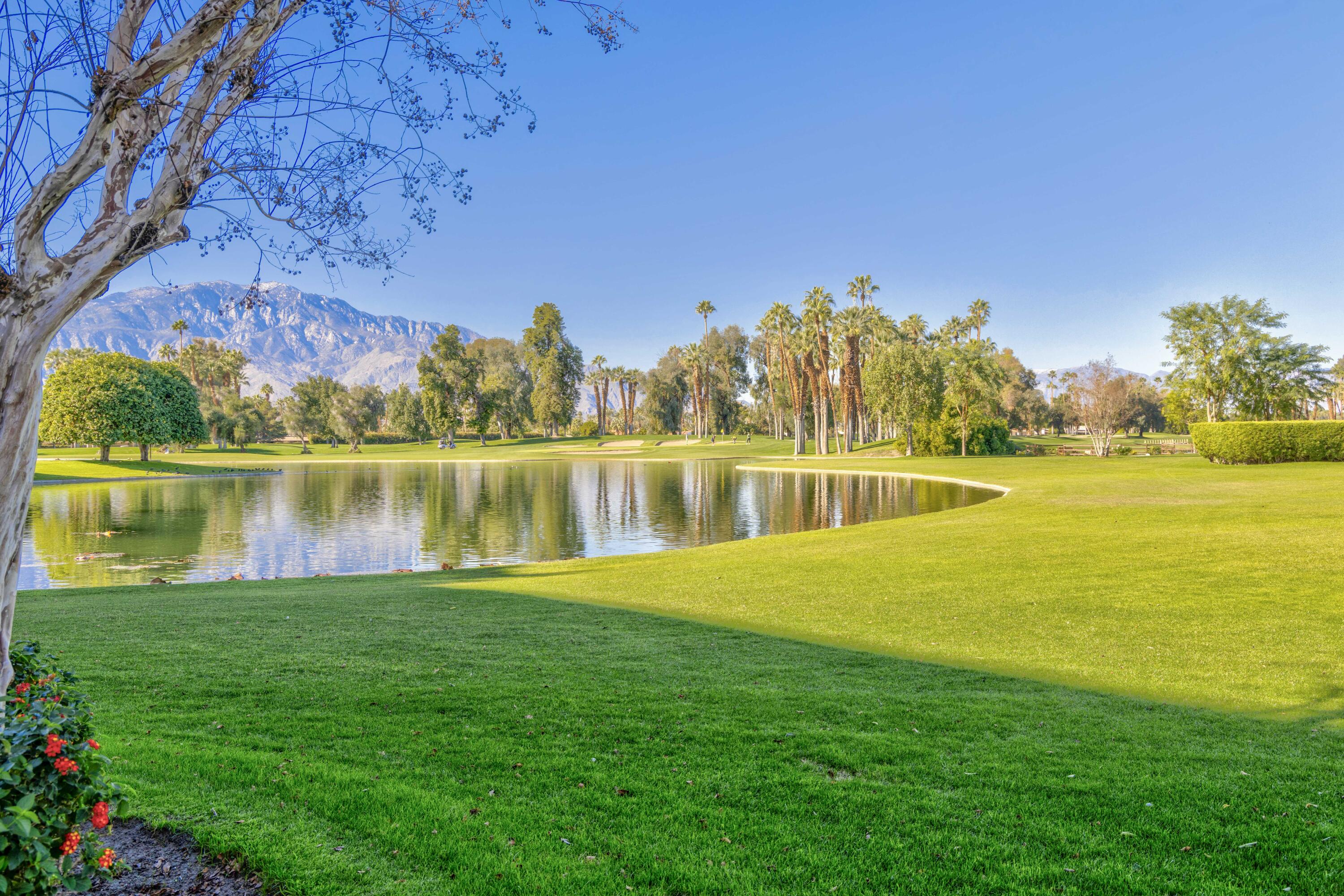 899 Island Drive, Unit 402 Rancho Mirage, CA 92270 - Photo 38 of 40 a view of a lake with houses in the back