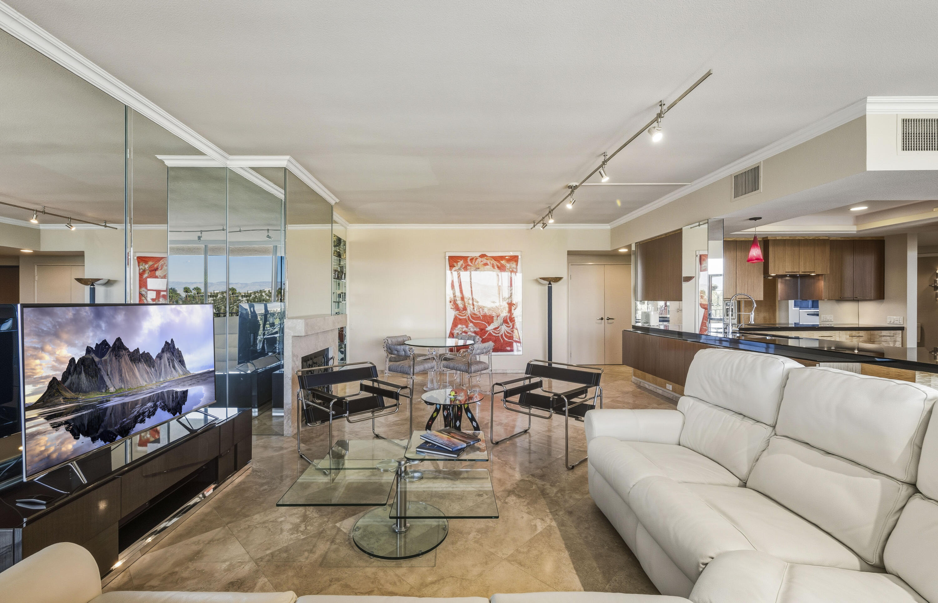 899 Island Drive, Unit 402 Rancho Mirage, CA 92270 - Photo 4 of 40 a living room with lots of furniture and a view of kitchen