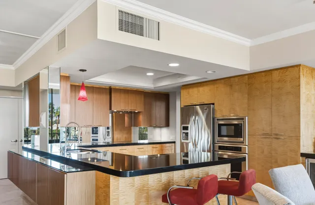 a kitchen with stainless steel appliances granite countertop a sink and a counter top space