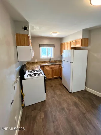 a kitchen with a refrigerator and a stove
