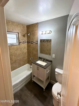 a bathroom with a toilet a sink and bathtub