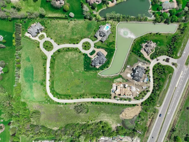 an aerial view of a residential houses with outdoor space and street view