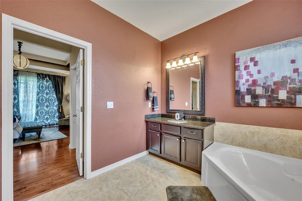 4946 Northeast 124th Road Oxford, FL 34484 - Photo 32 of 69 a spacious bathroom with a tub double vanity sink and a mirror