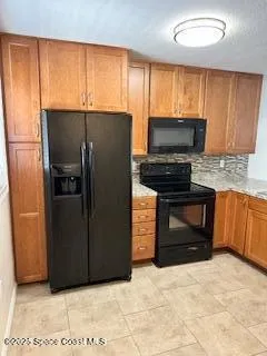 a kitchen with stainless steel appliances granite countertop a refrigerator microwave and sink