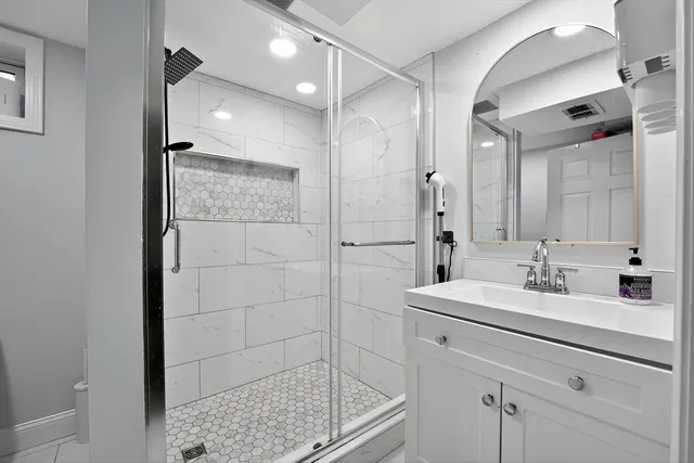 a bathroom with a granite countertop sink a toilet and a mirror