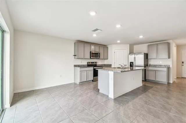 a large kitchen with white cabinets