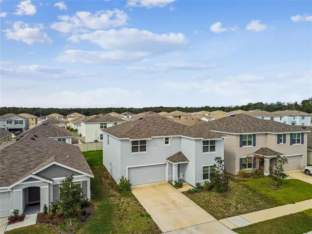 an aerial view of residential houses with a city view