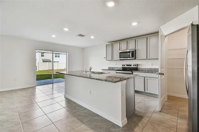 a kitchen with cabinets and stainless steel appliances
