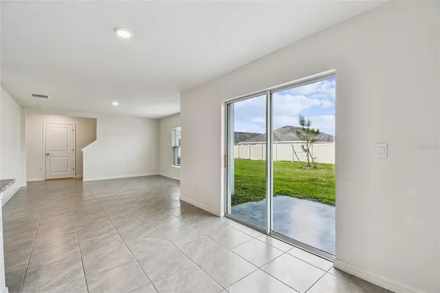 a view of empty room with floor to ceiling window