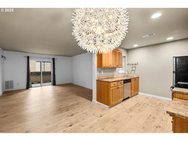 a kitchen with a refrigerator and a sink