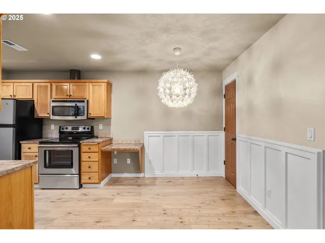 a view of kitchen with microwave and refrigerator