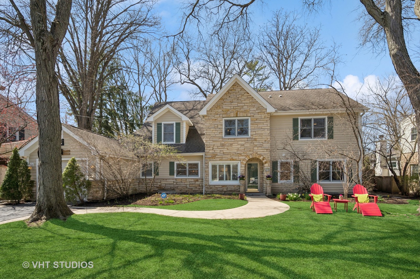 a front view of house with yard and green space