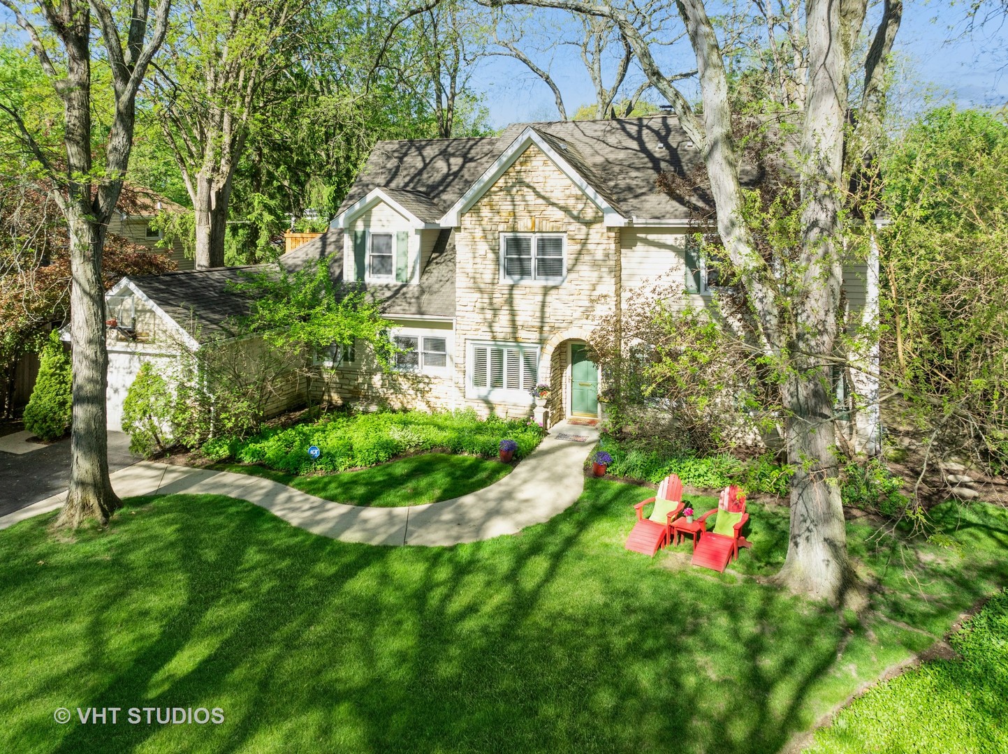 630 Juniper Road Glenview, IL 60025 - Photo 2 of 52 a view of a white house with a yard and garden