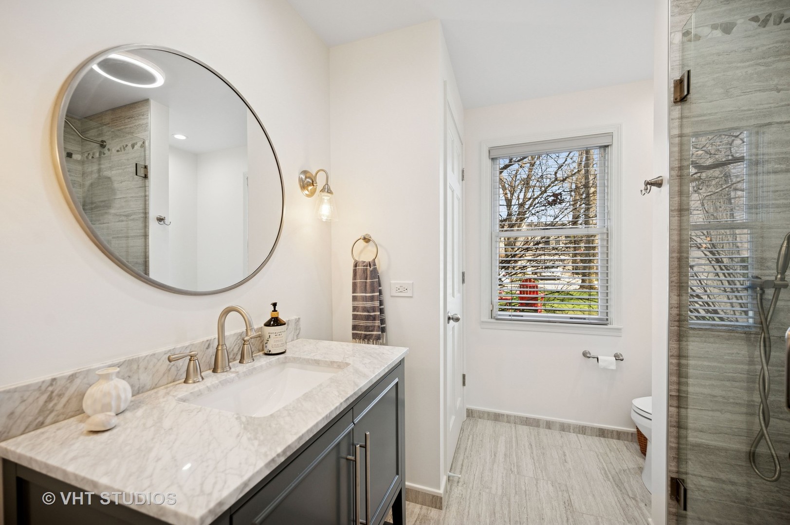 630 Juniper Road Glenview, IL 60025 - Photo 27 of 52 a bathroom with a granite countertop sink a mirror and shower
