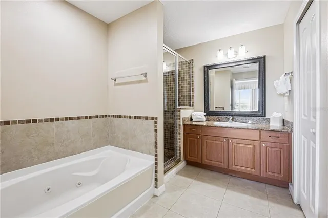 a bathroom with a granite countertop sink a mirror and a shower