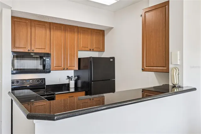 a bedroom with a large bed and a flat tv screen on dresser