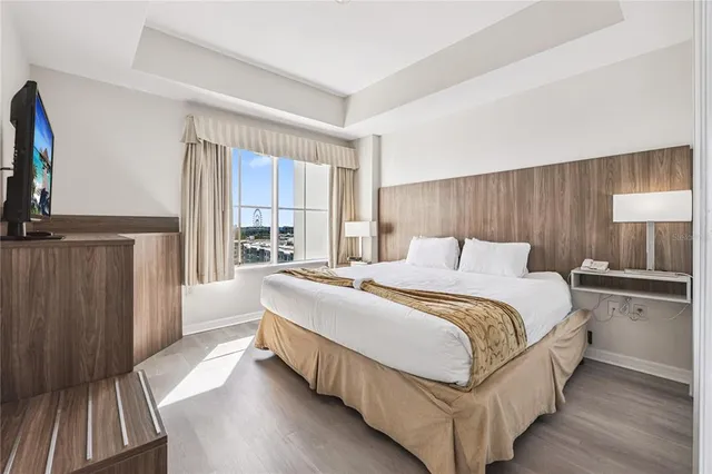 a bed sitting in a bedroom next to a window