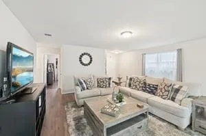 a living room with furniture and a flat screen tv