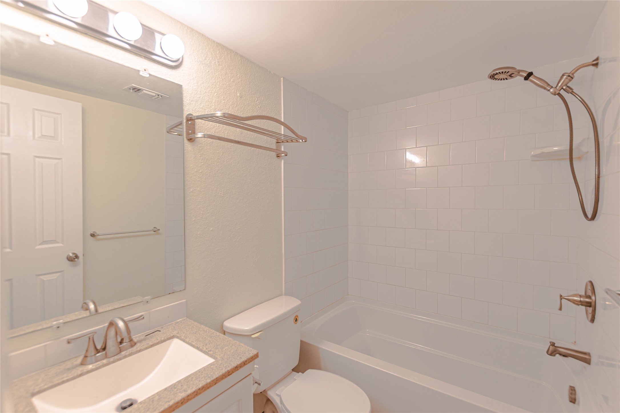 2500 Burleson Road, Unit 601 Austin, TX 78741 - Photo 12 of 20 a bathroom with a granite countertop sink a toilet and shower